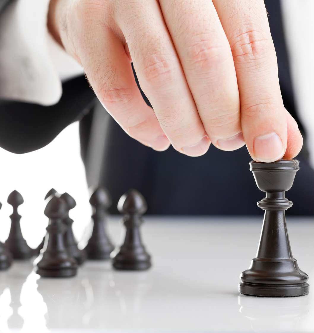 Hand bewegt Schachfiguren: Führungskräftevorsorgung